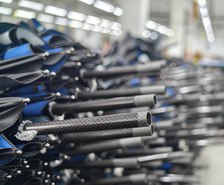 Carbon-fiber umbrella components arranged during production for a 16,000-piece custom order